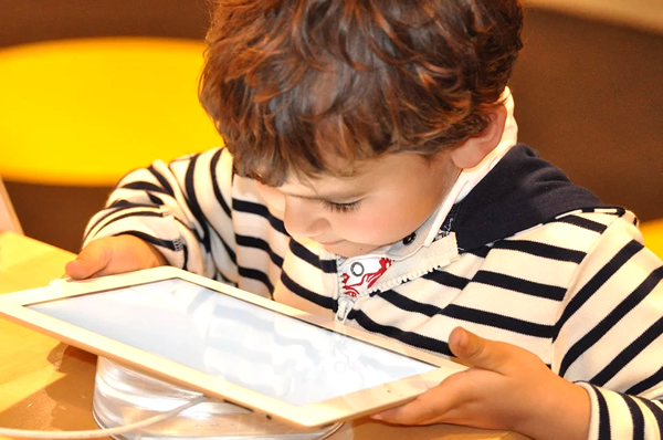niño viendo series en una tablet con los códigos de netflix